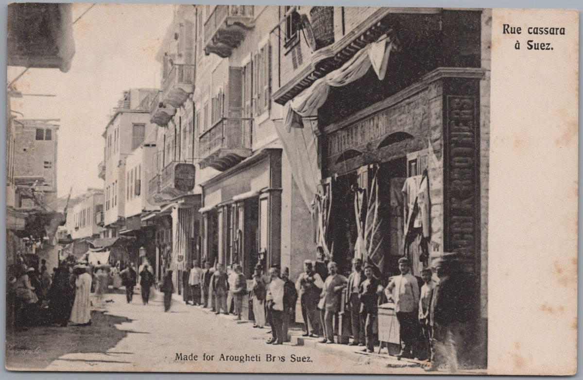 PC02010 front — Suez — Rue Cassara Shops and Street Crowd
