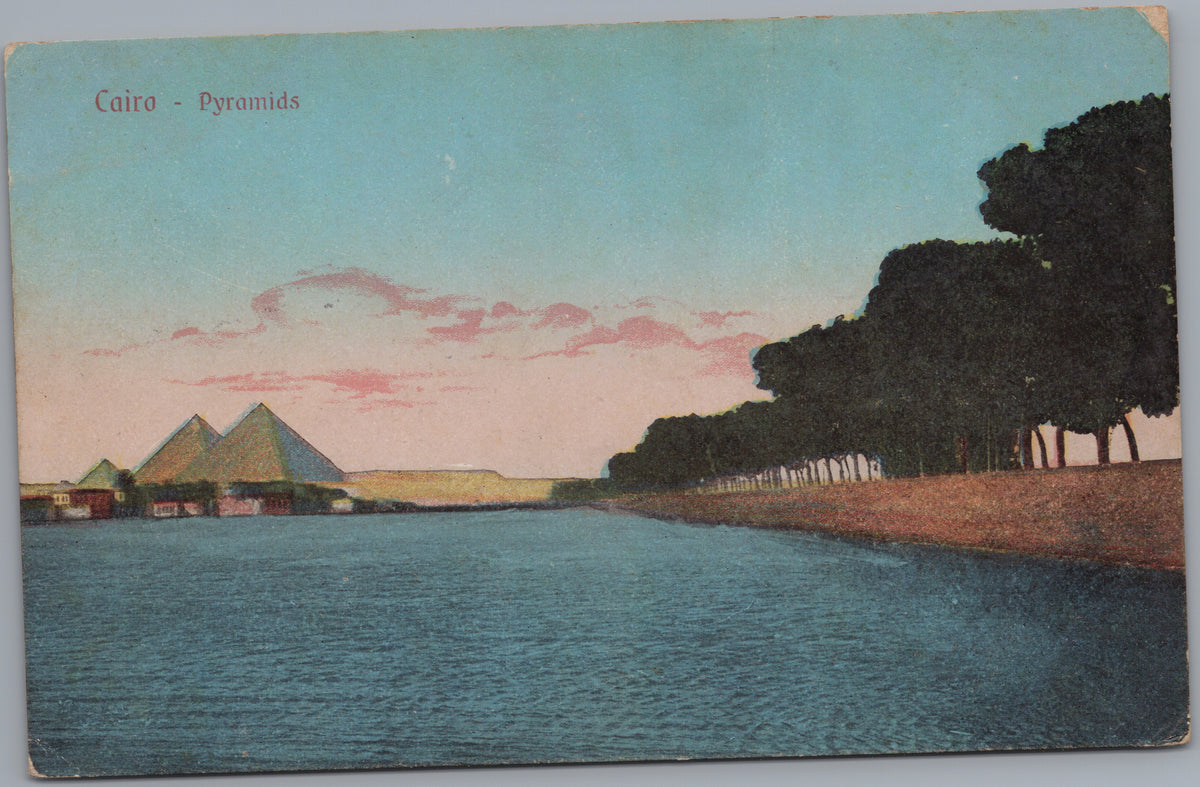 PC02191 front — Distant Pyramids across Water and Tree-Lined Bank