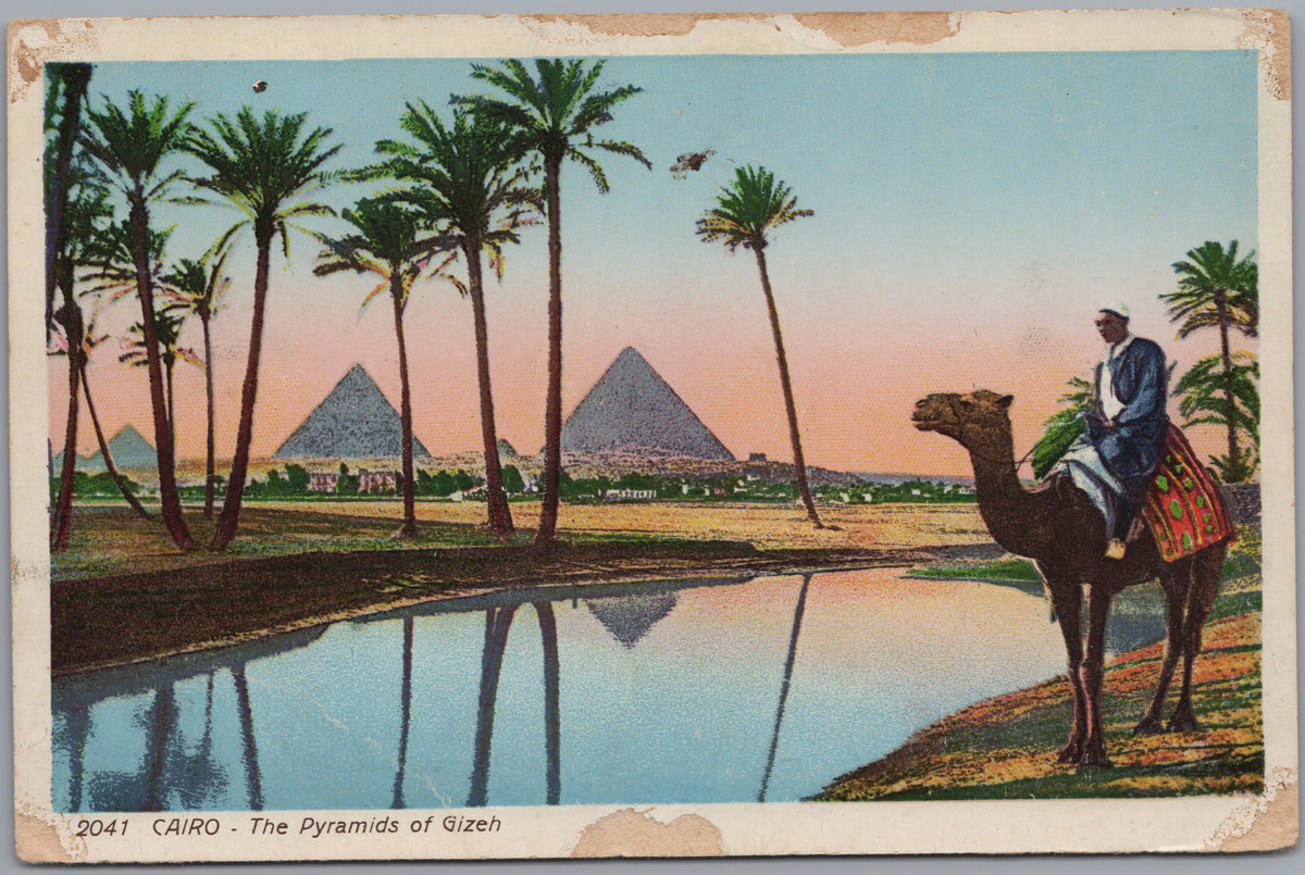 PC02213 front — Camel Rider beside a Pool and Palm-Framed Pyramids