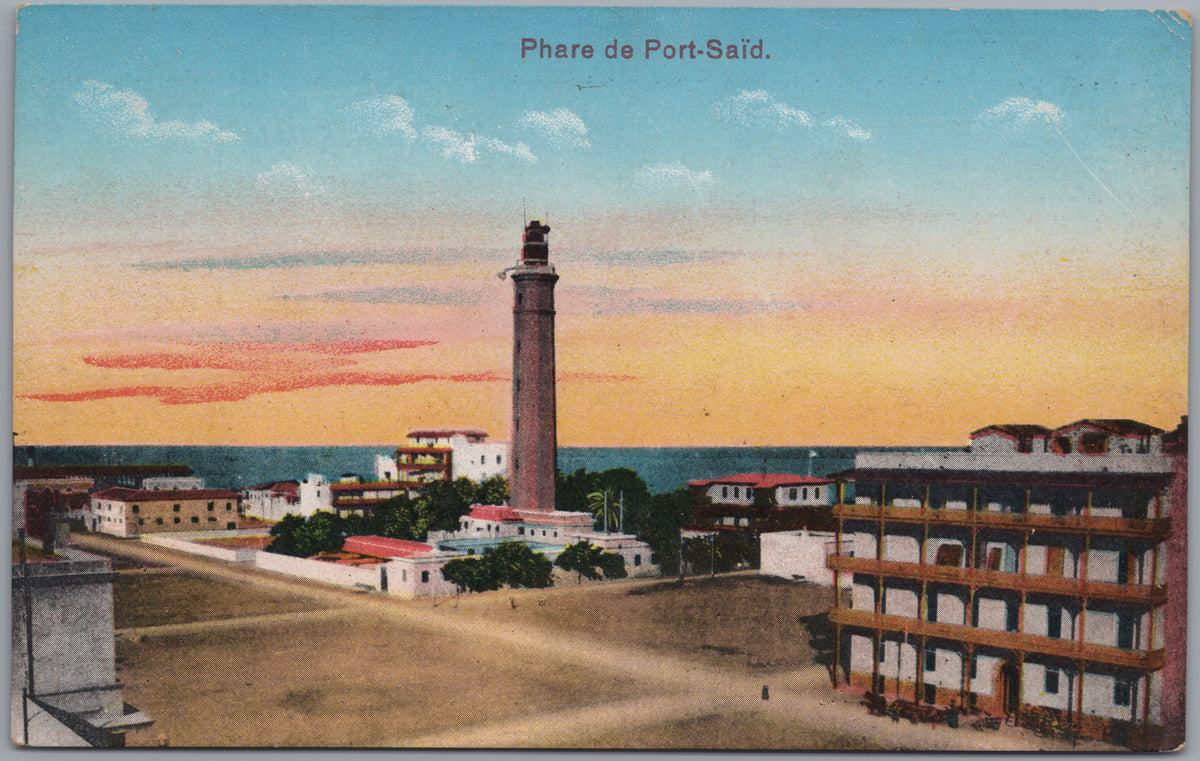 PC02323 front — Lighthouse and Town at Sunset