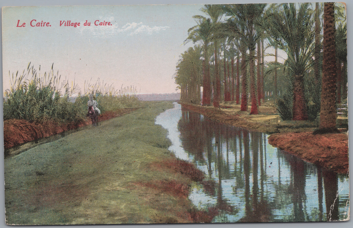 PC02343 front — Village Waterway and Palm-Lined Path